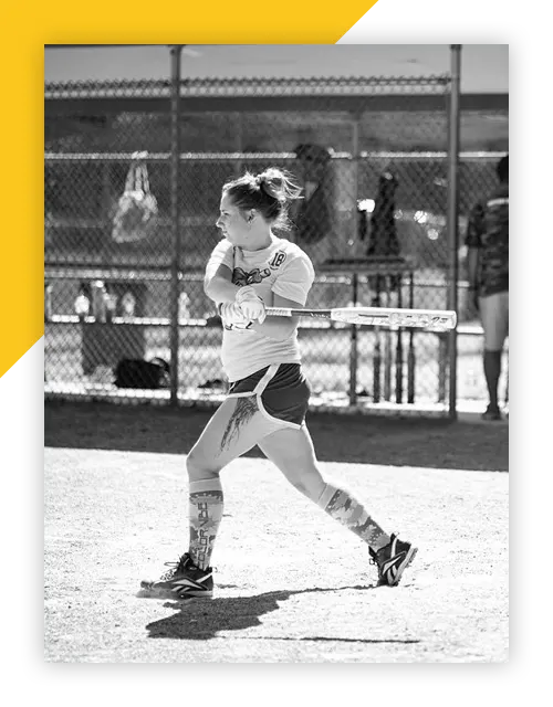 Rachel Caron swinging a bat at home plate